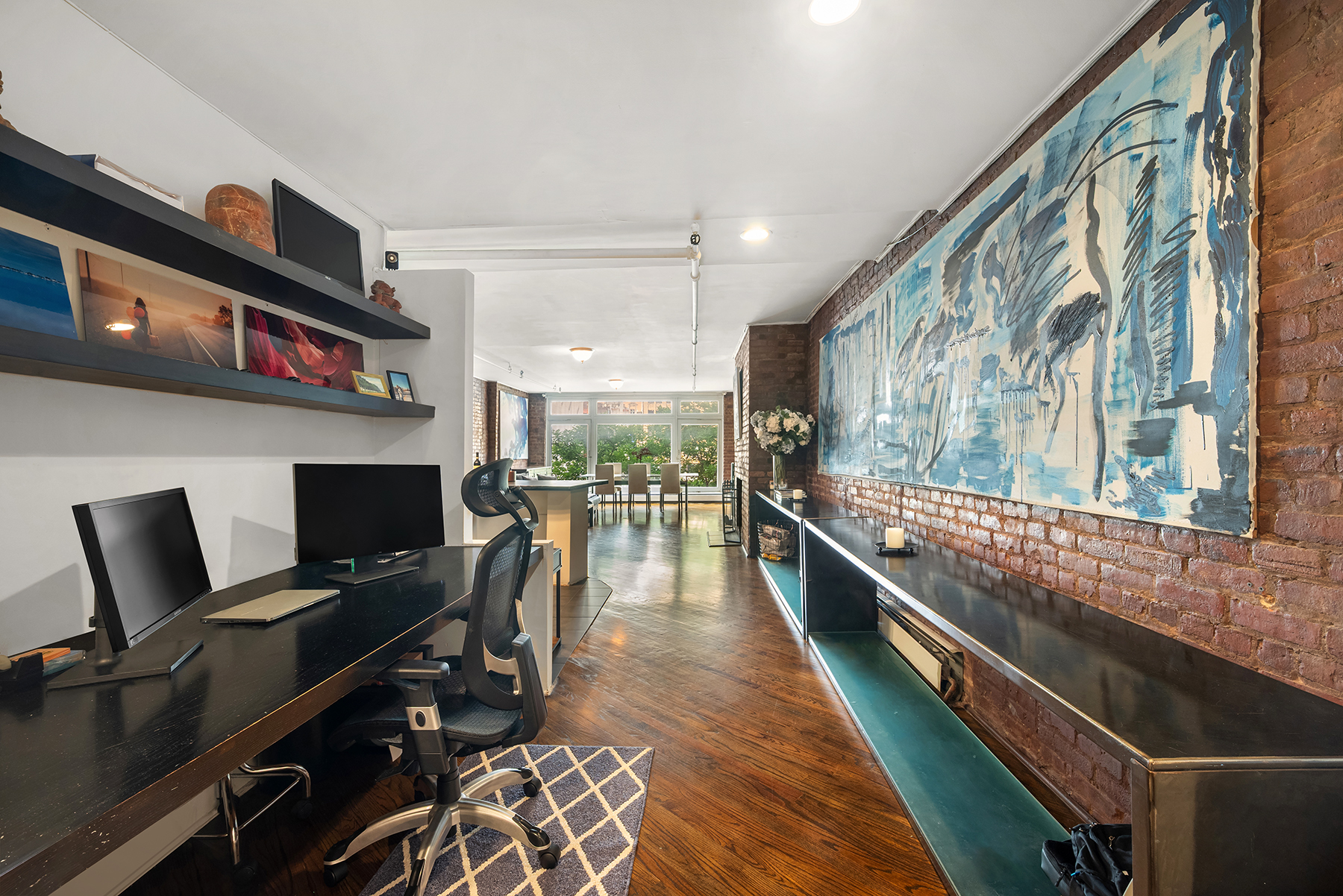 12 West 29th Street, Unit 4 Manhattan, NY 10001 - Photo 7 of 13 a kitchen with stainless steel appliances kitchen island granite countertop a stove and a view of living room