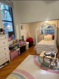 a bedroom with a bed and a mirror