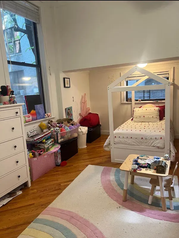 a bedroom with a bed and a mirror