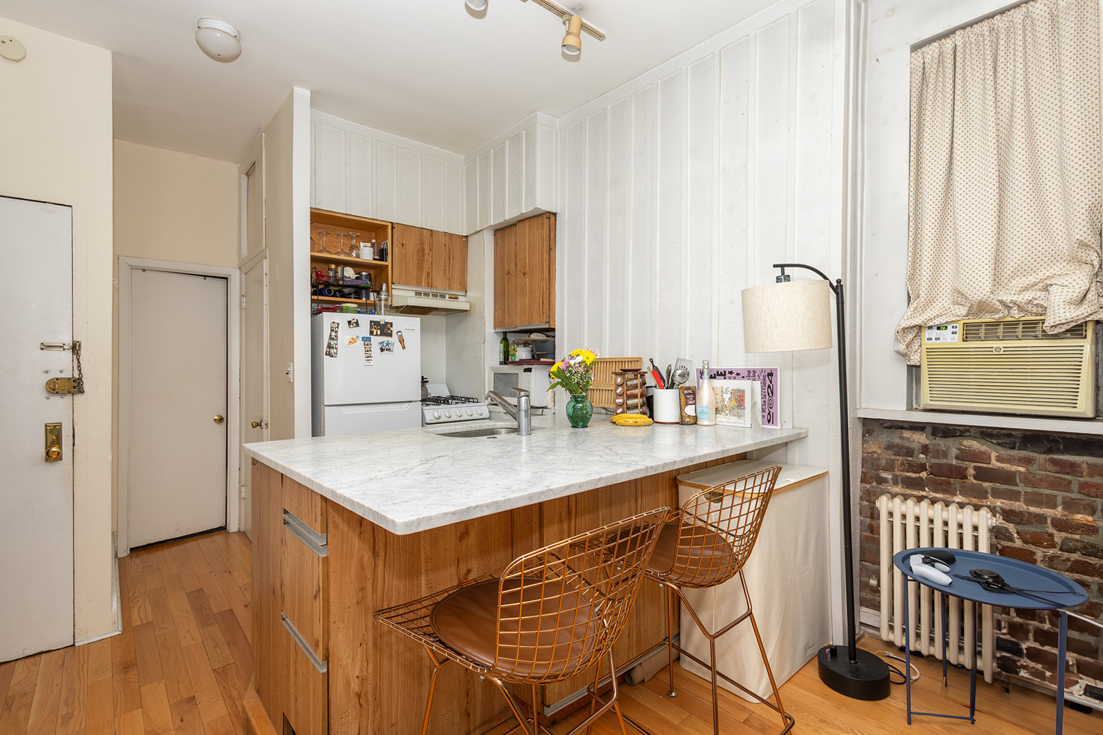 147 Sullivan Street, Unit 2A Manhattan, NY 10012 - Photo 4 of 8 a kitchen with stainless steel appliances kitchen island granite countertop a sink and cabinets