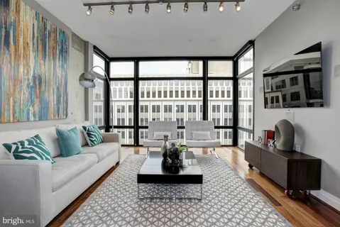 a living room with furniture and a large window