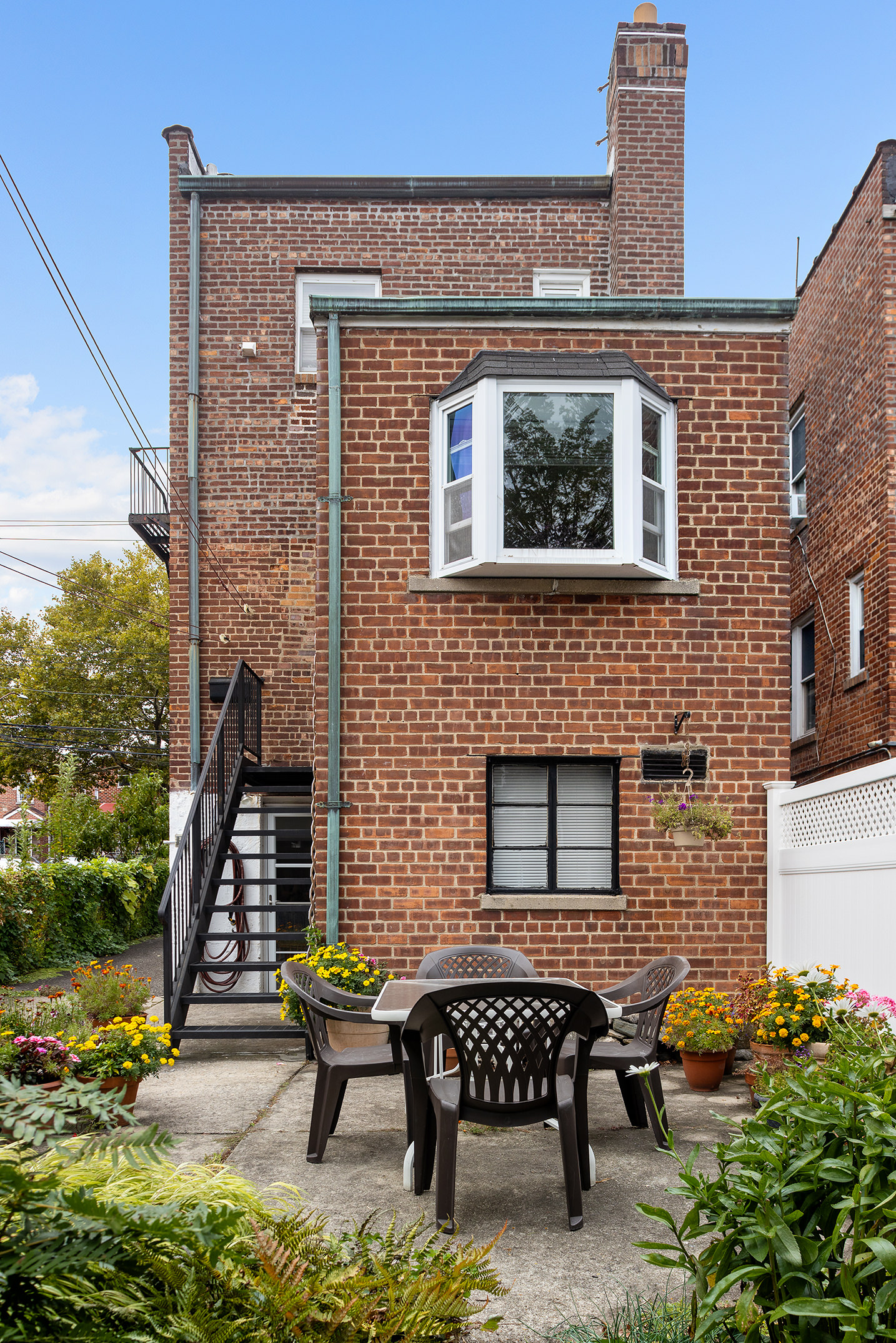 2536 Lurting Avenue Bronx, NY 10469 - Photo 23 of 27 a brick building with a bench in front of it