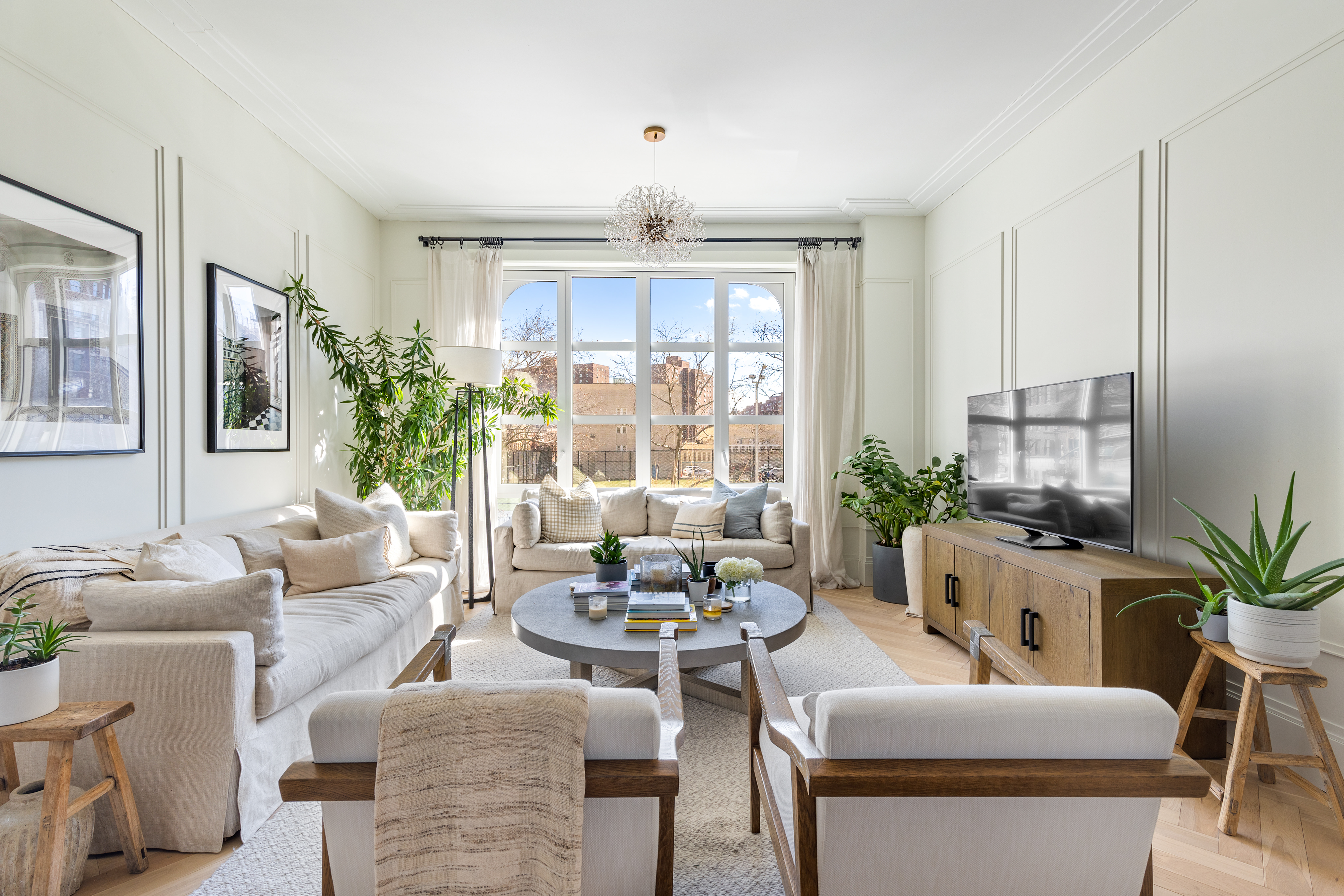 250 East 21st Street, Unit 2B Manhattan, NY 10010 - Photo 1 of 9 a living room with furniture and a large window