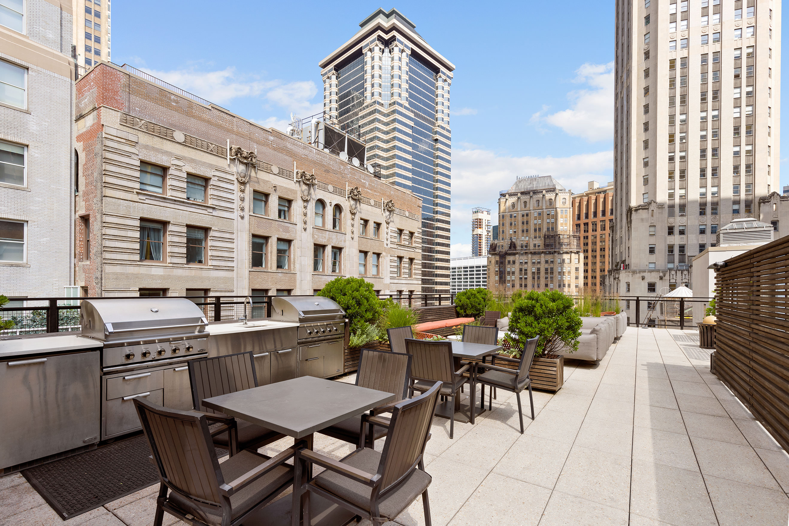 25 Broad Street, Unit 6T Manhattan, NY 10004 - Photo 10 of 13 a view of a patio with a table and chairs and potted plants