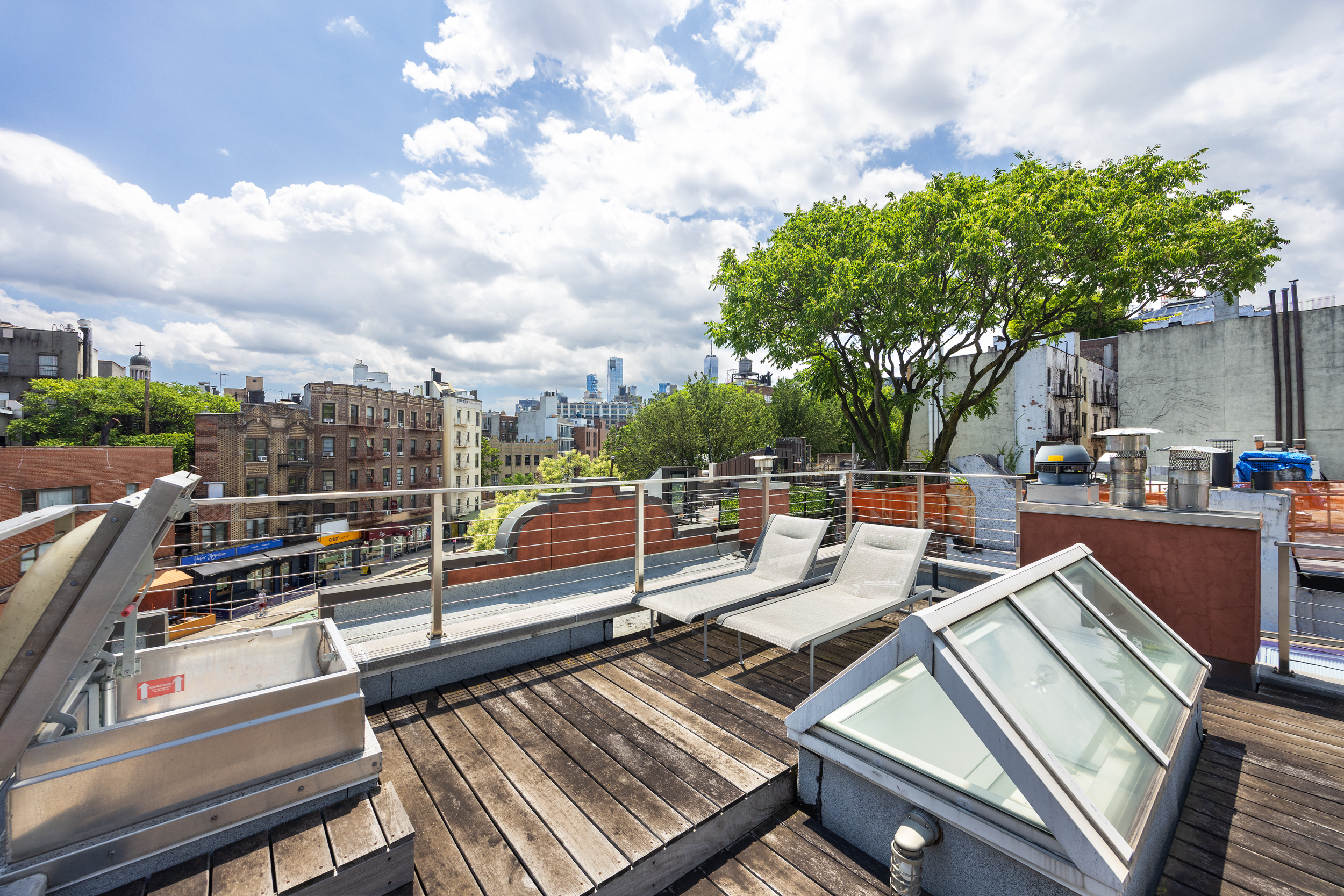 39 Barrow Street Manhattan, NY 10014 - Photo 31 of 39 a view of a roof deck with couches and wooden floor