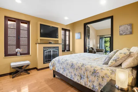 a bedroom with a bed and a flat screen tv