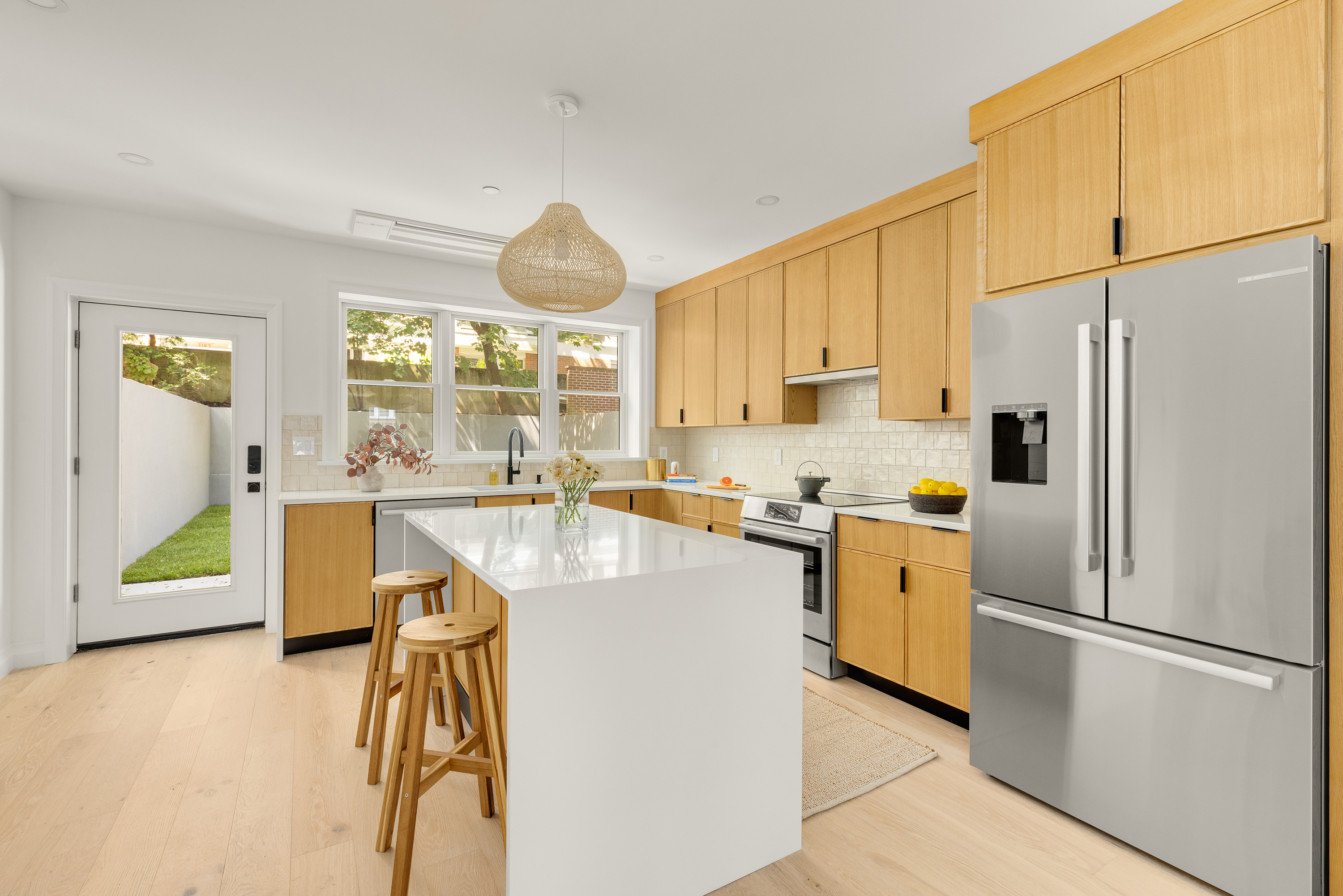 578 20th Street Brooklyn, NY 11218 - Photo 5 of 28 a kitchen with stainless steel appliances a refrigerator sink and white cabinets