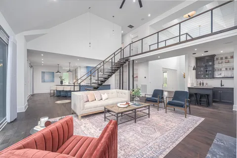 a large kitchen with kitchen island a stove a sink a center island and windows