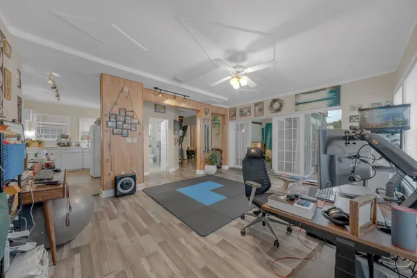 a room with stainless steel appliances kitchen island granite countertop furniture and a refrigerator