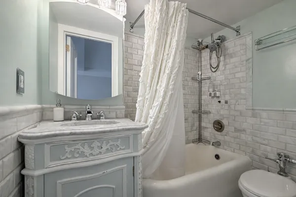 a bathroom with a sink toilet tub and shower