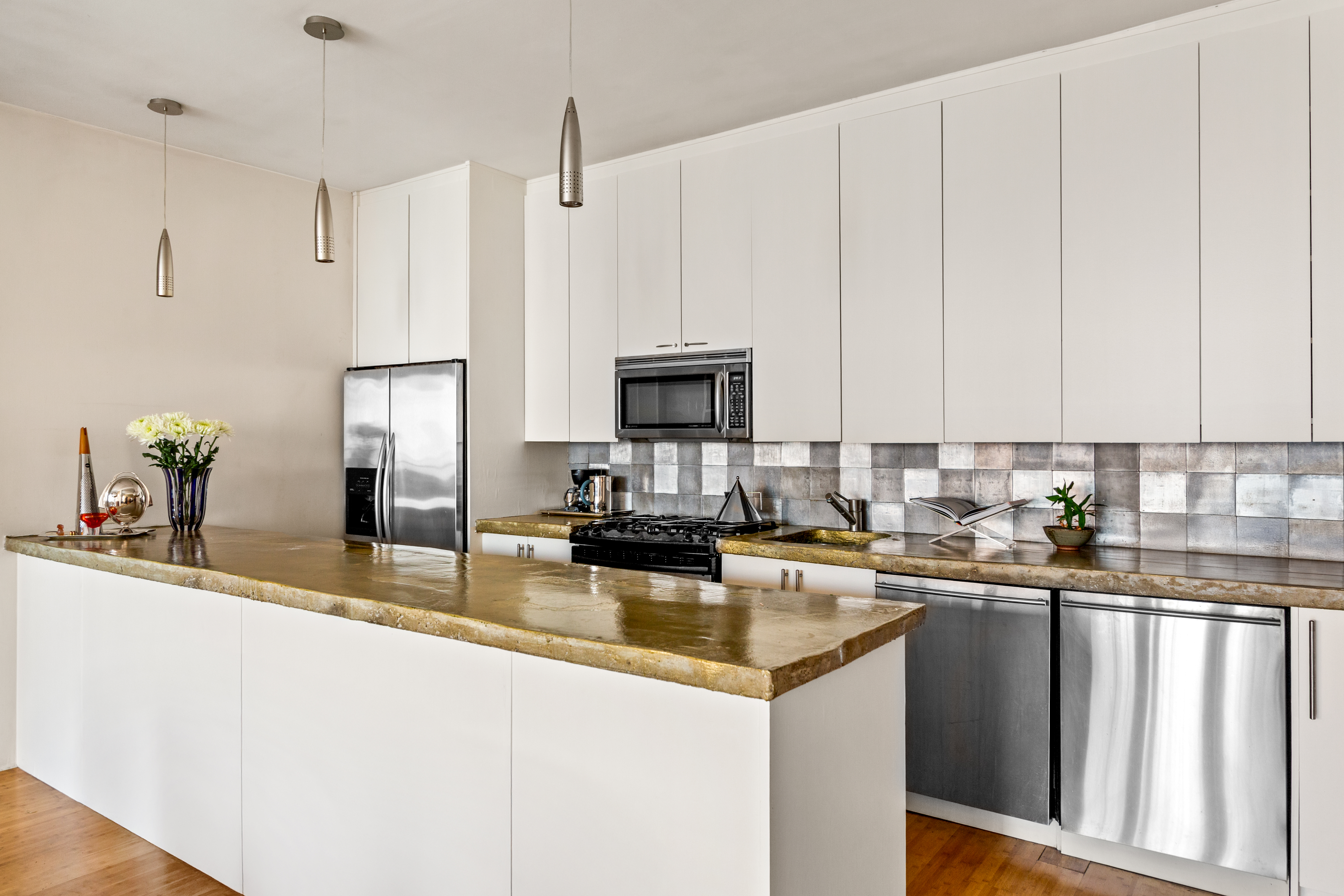 529 West 42nd Street, Unit 7A Manhattan, NY 10036 - Photo 5 of 18 a kitchen with stainless steel appliances granite countertop a sink a stove and refrigerator