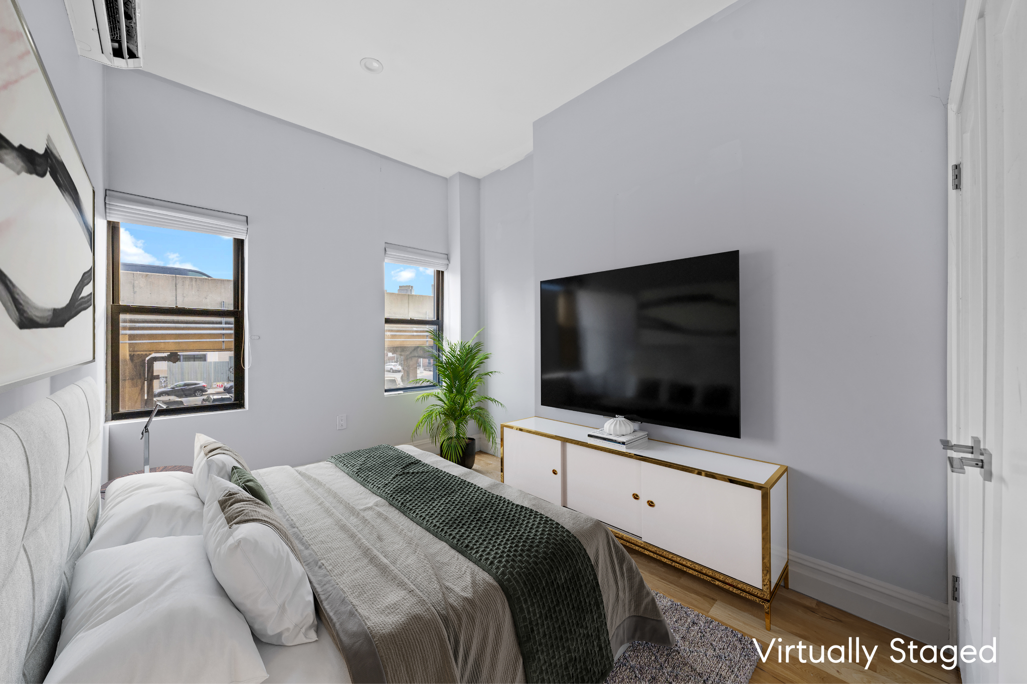 181 Park Avenue Brooklyn, NY 11205 - Photo 10 of 19 a bedroom with a flat screen tv and a bed