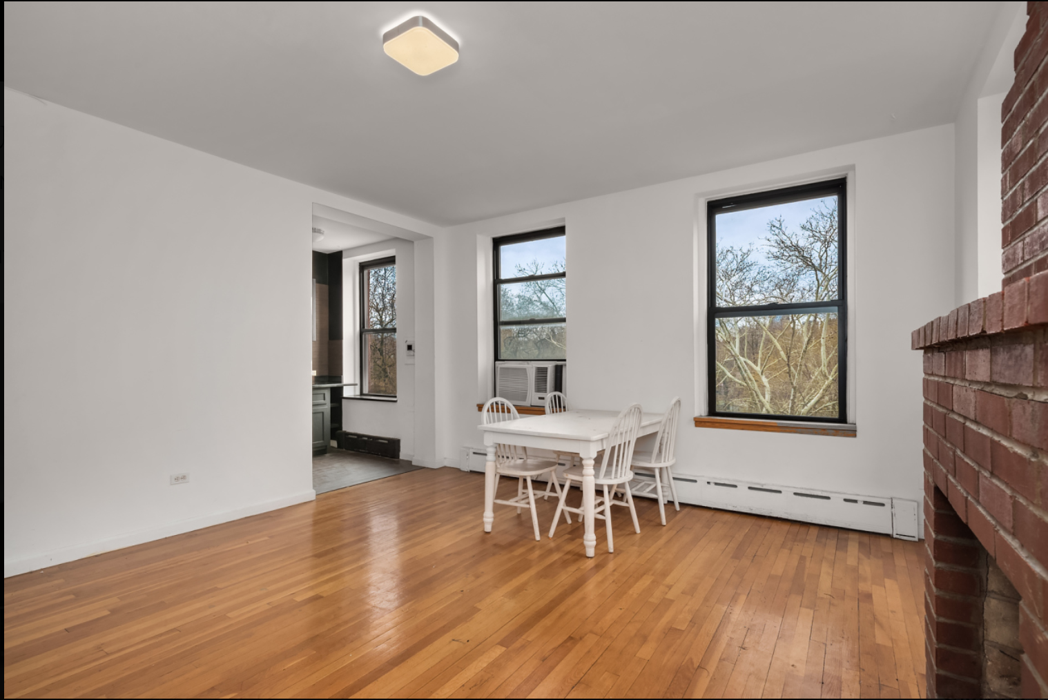 293 East 10th Street, Unit 4 Manhattan, NY 10009 - Photo 3 of 8 a living room with furniture and a wooden floor