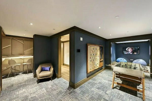 a view of roof deck with outdoor seating and city view