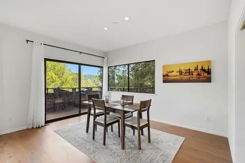 a view of a dining room with furniture window and wooden floor