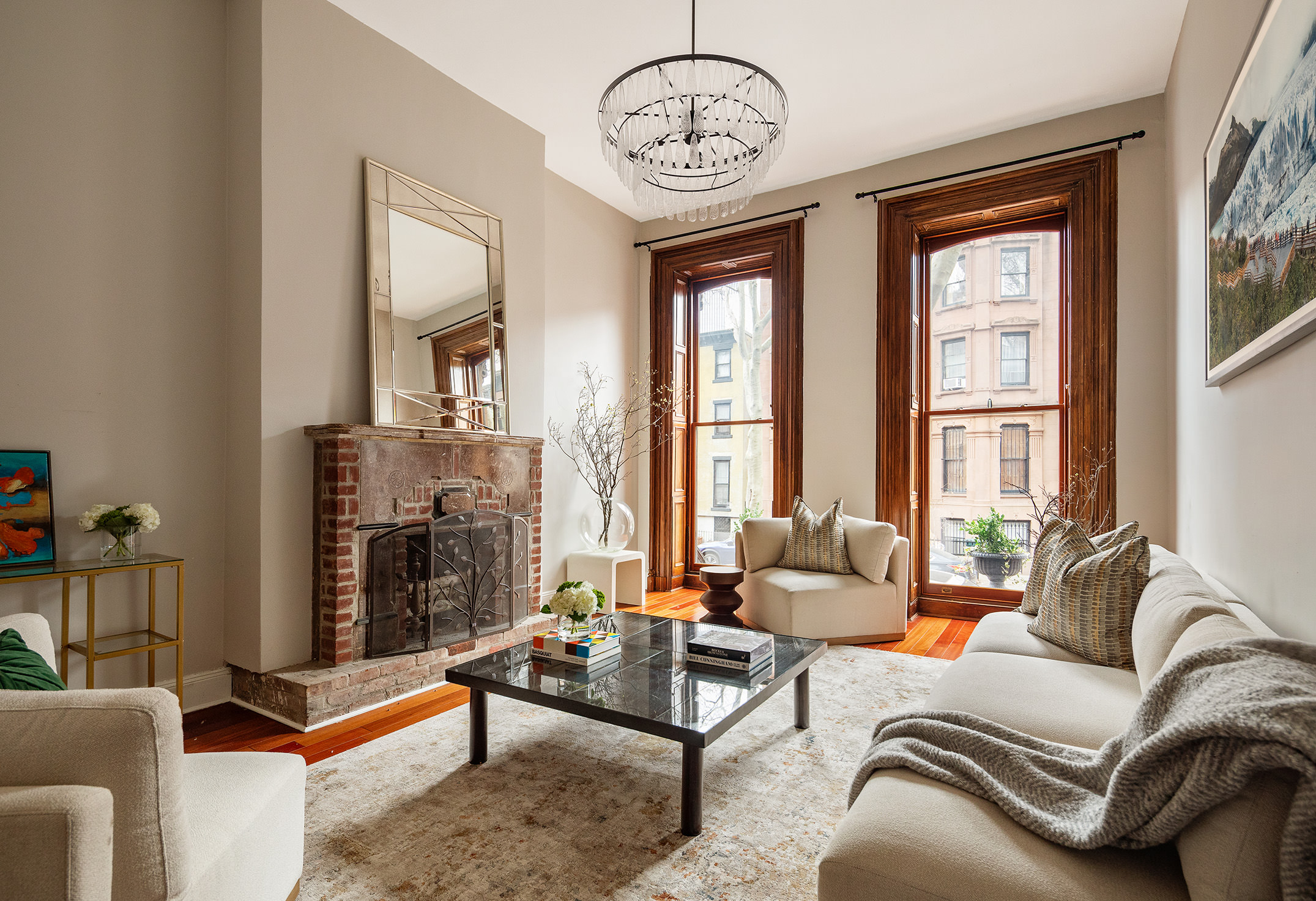a living room with furniture a fireplace and a large window