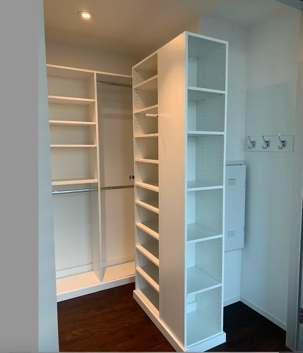 a view of walk in closet with empty racks