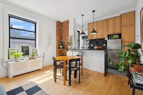 a kitchen with a table chairs and a couch