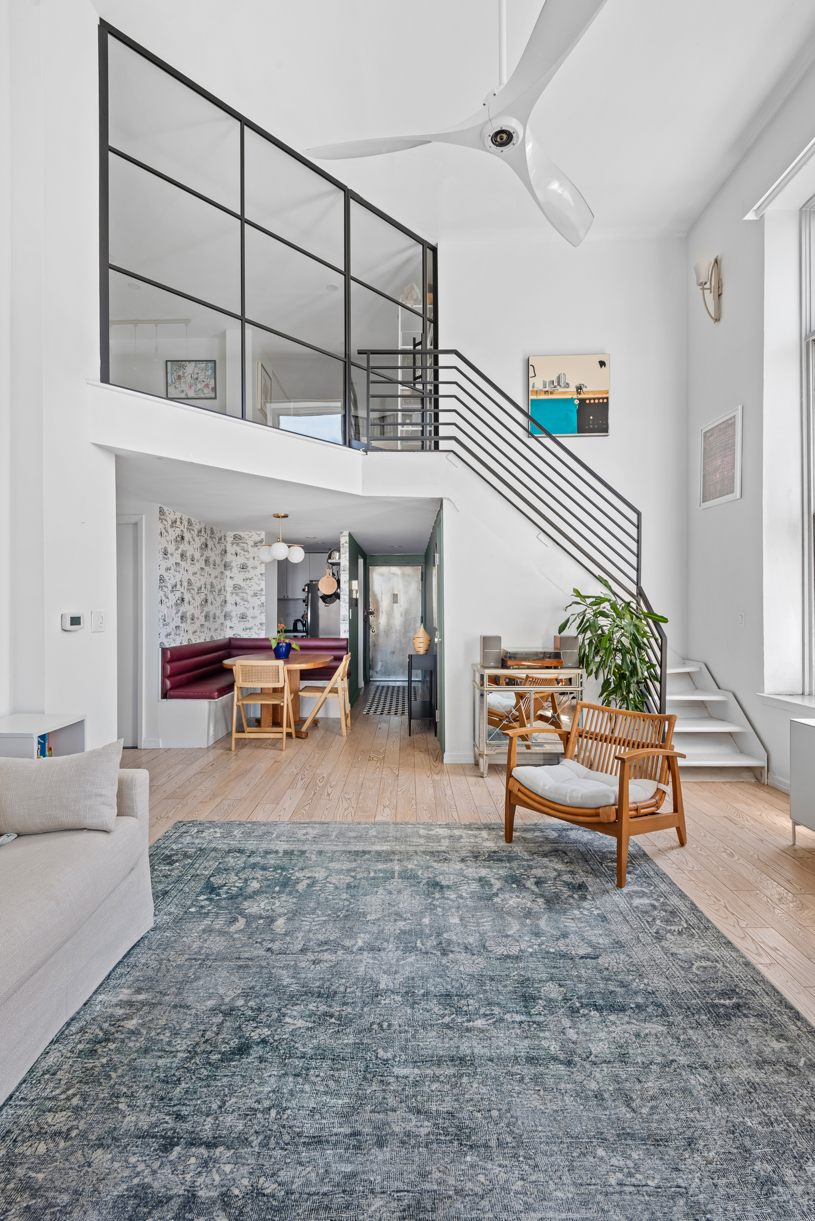 55 Poplar Street, Unit 4K Brooklyn, NY 11201 - Photo 2 of 15 a living room with furniture a rug and a large window