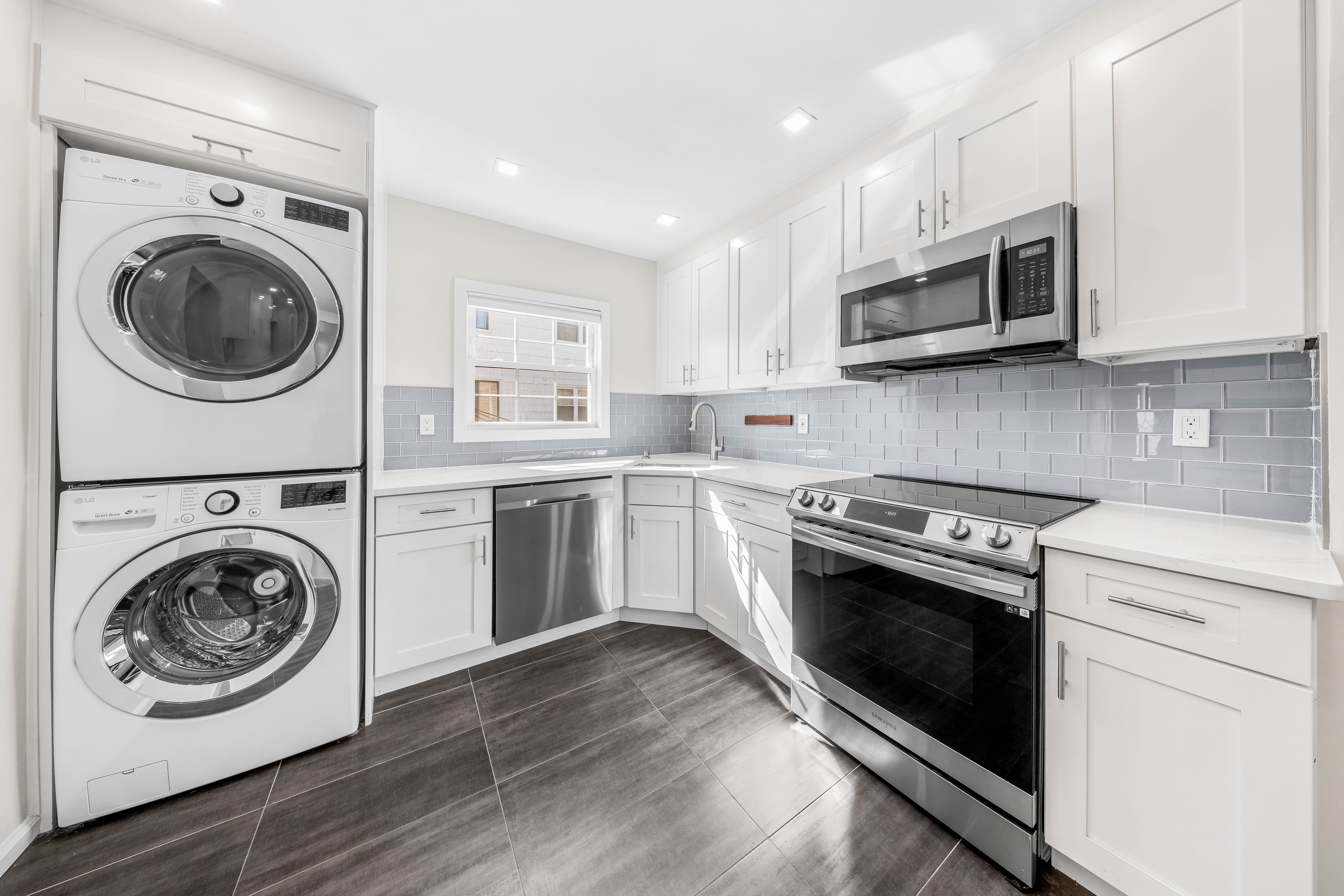 15-80 209th Street, Unit 2 Queens, NY 11360 - Photo 7 of 21 a kitchen with stainless steel appliances a stove top oven and cabinets