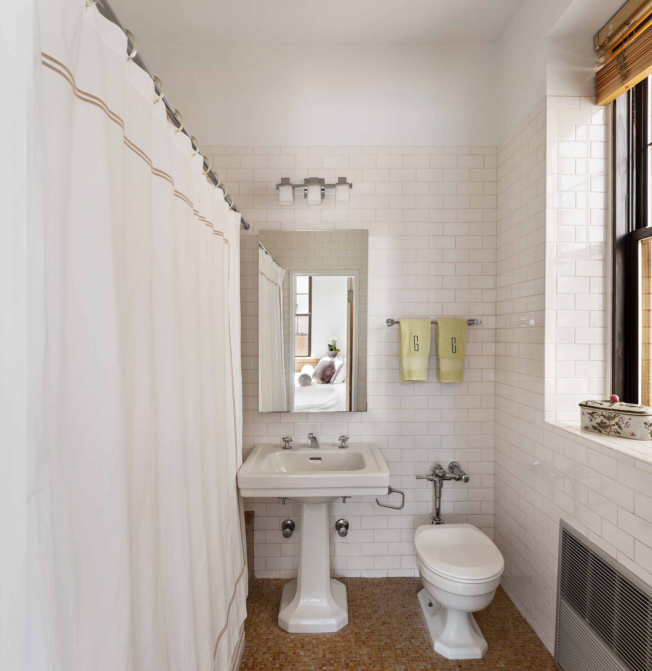 521 Park Avenue, Unit 10A Manhattan, NY 10065 - Photo 5 of 11 a bathroom with a toilet sink and mirror