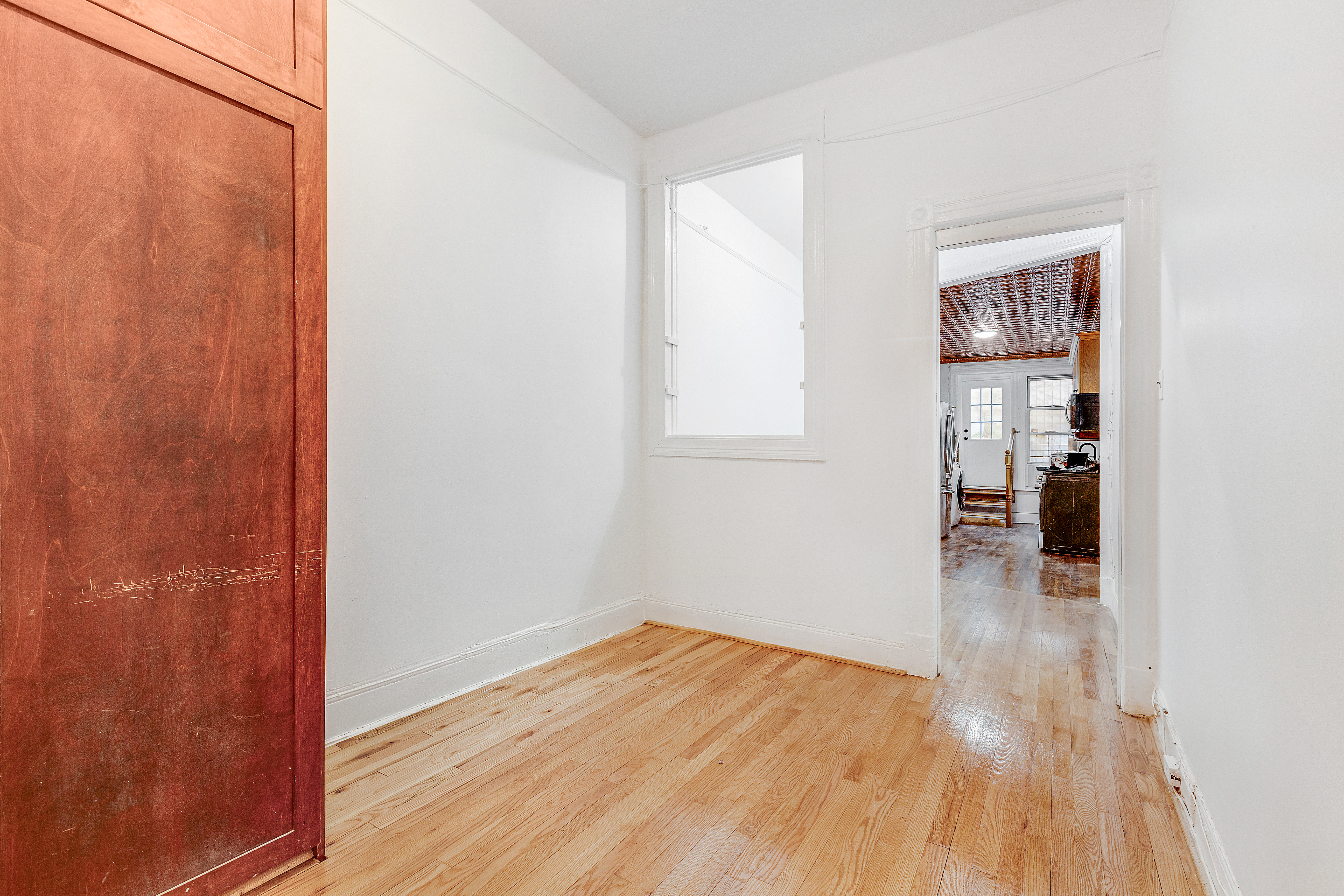 639 President Street, Unit 1L Brooklyn, NY 11215 - Photo 7 of 12 an empty room with wooden floor and a bathroom