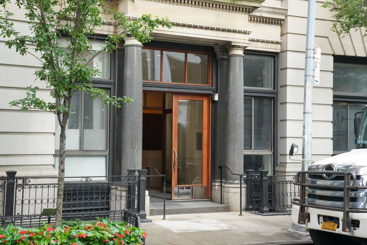 303 Mercer Street, Unit A406 Manhattan, NY 10003 - Photo 10 of 11 a front view of a house with garden