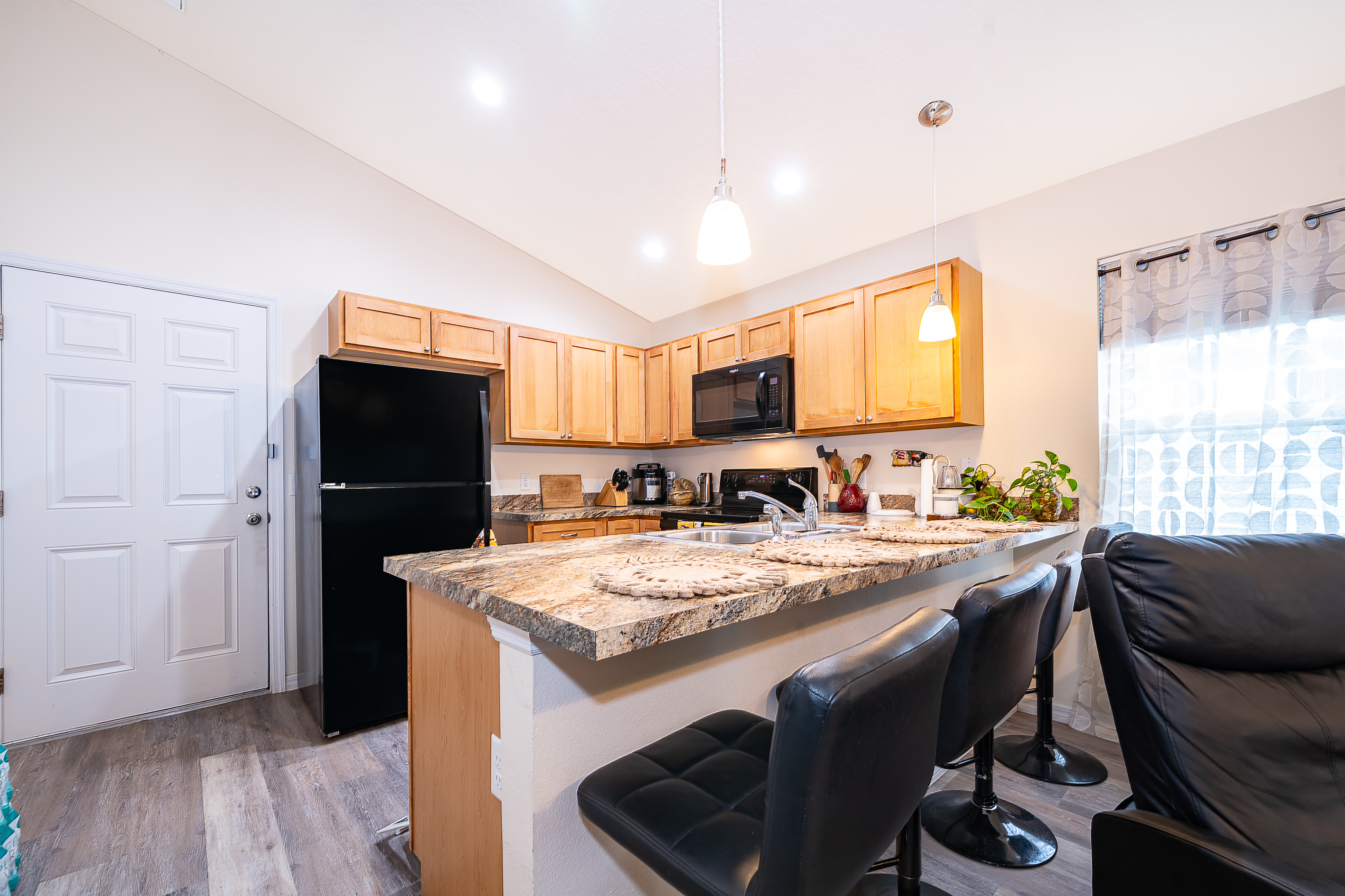1360 Cottage Circle Tavares, FL 32778 - Photo 9 of 25 a kitchen with stainless steel appliances granite countertop a sink refrigerator and microwave