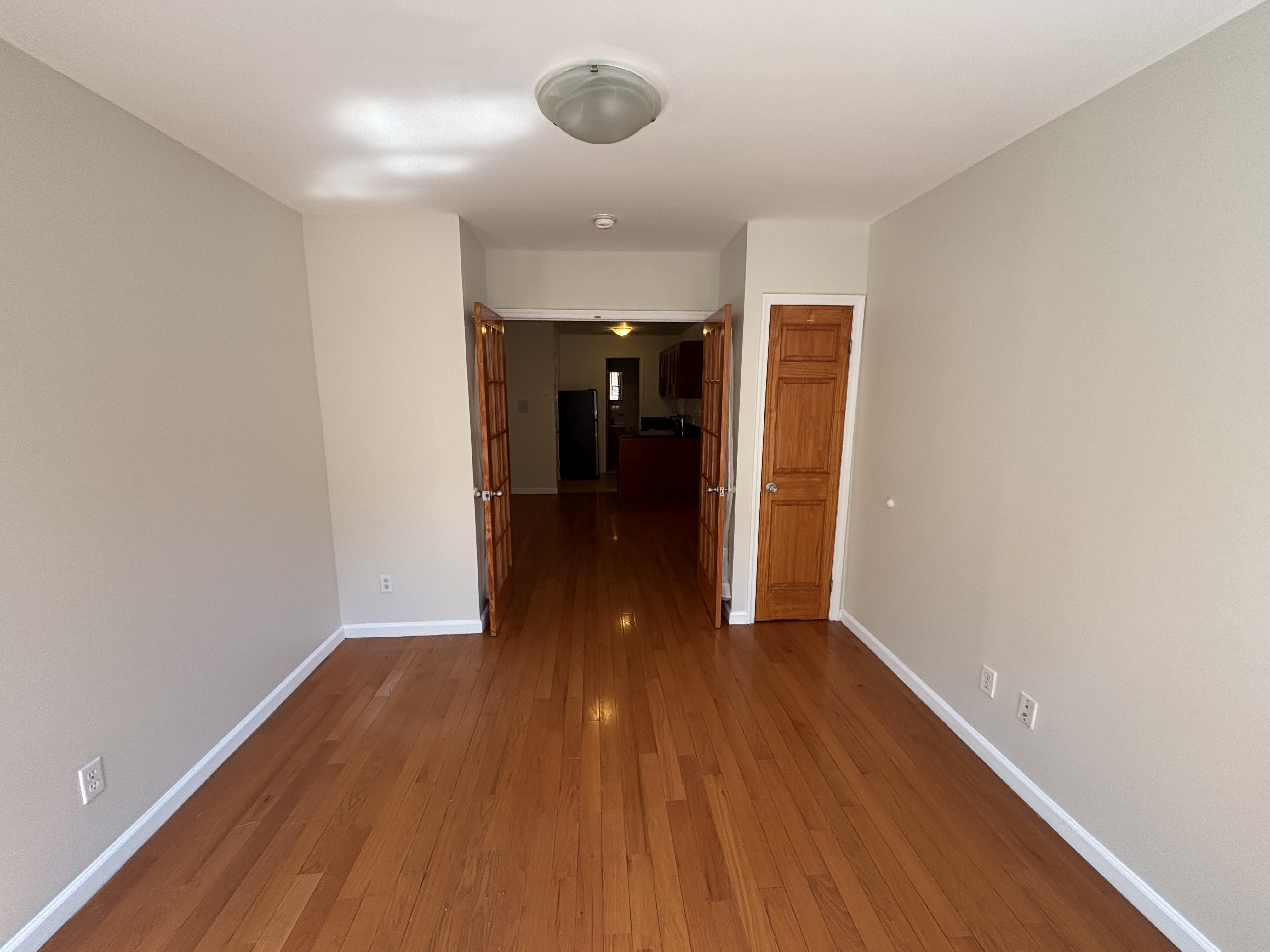 99 St Marks Place, Unit 4B Manhattan, NY 10009 - Photo 4 of 10 a view of a room with wooden floor and a ceiling fan