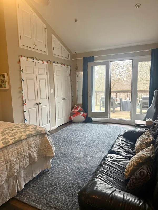 a bedroom with bed and window