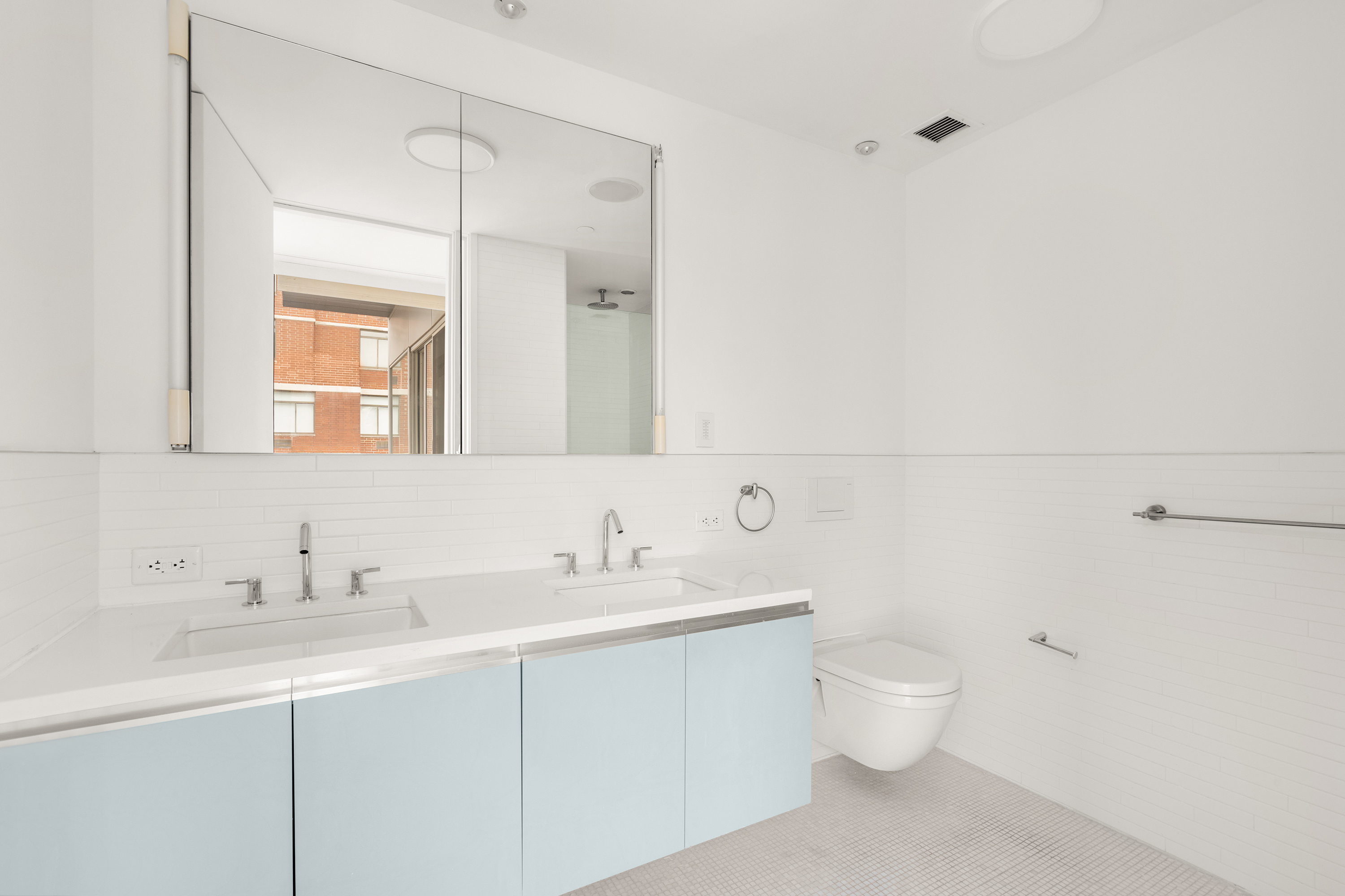 245 West 19th Street, Unit PH4 Manhattan, NY 10011 - Photo 10 of 13 a bathroom with a toilet sink and mirror