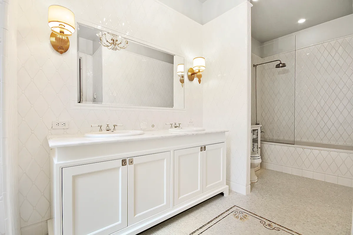 1 Central Park South, Unit 1010 Manhattan, NY 10019 - Photo 5 of 11 a bathroom with a double vanity sink a mirror and a shower