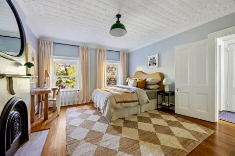 a bedroom with a bed and a chandelier