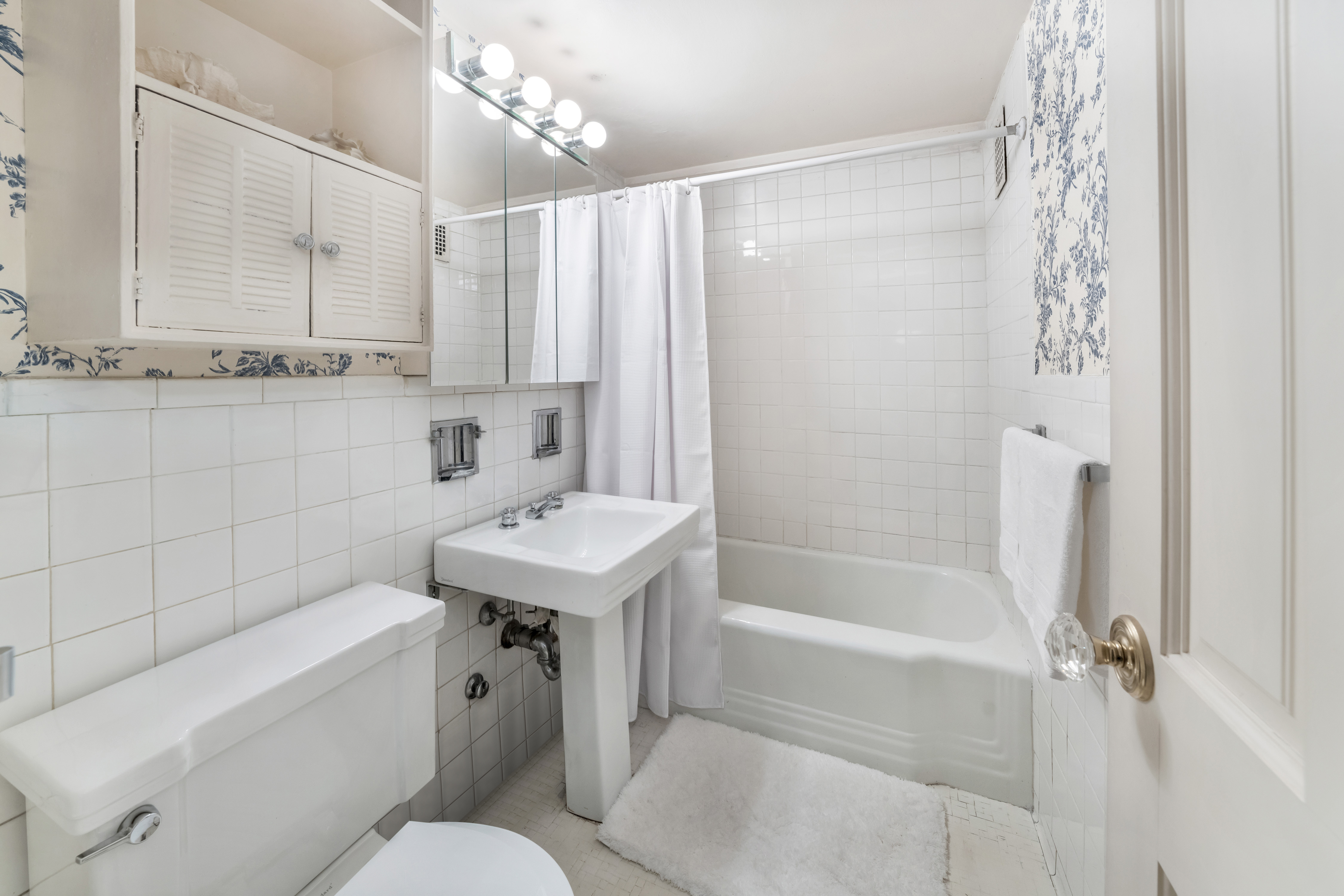 345 East 56th Street, Unit 5C Manhattan, NY 10022 - Photo 9 of 10 a bathroom with a sink toilet and shower