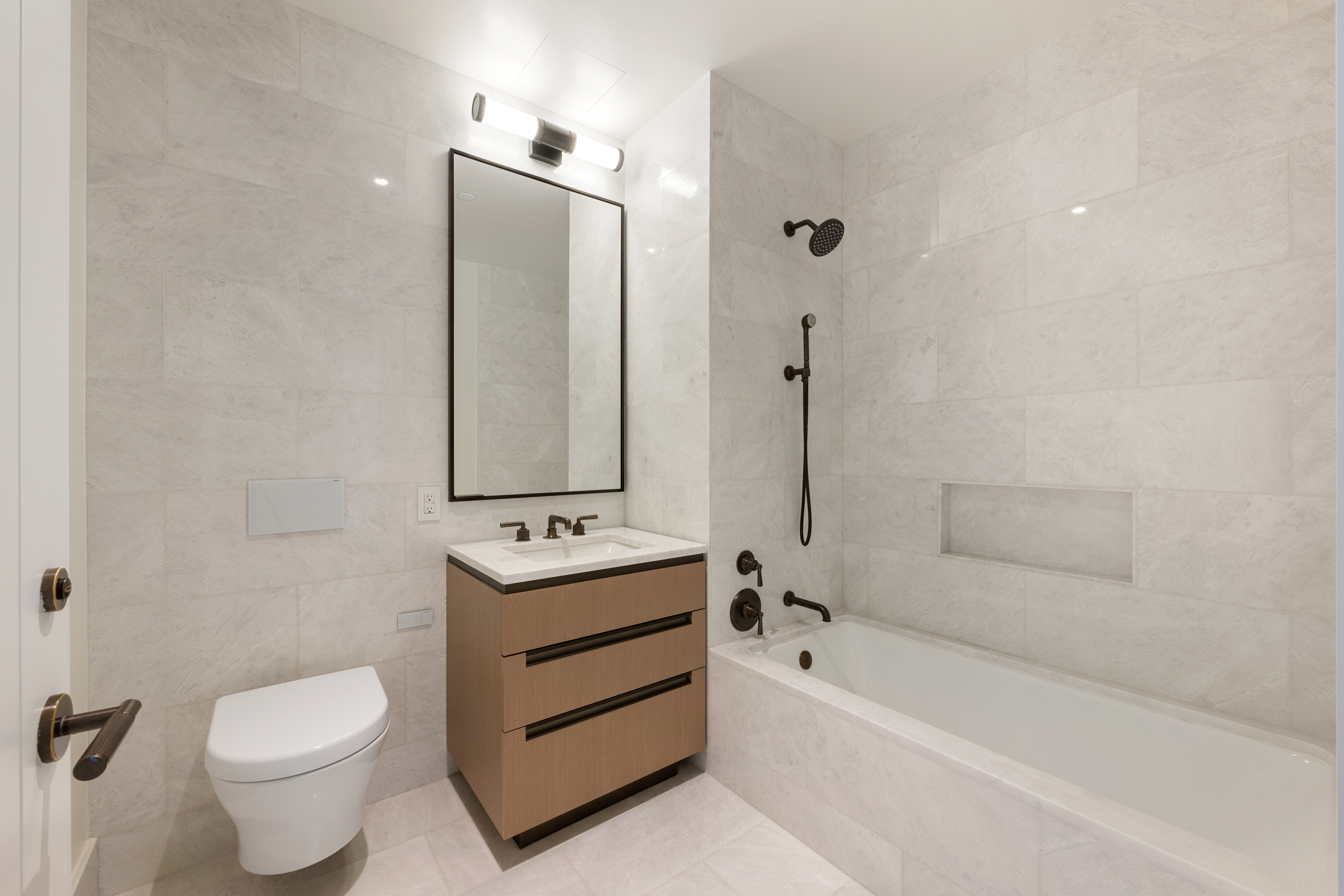 515 West 18th Street, Unit 1010 Manhattan, NY 10011 - Photo 7 of 19 a bathroom with a sink toilet and shower