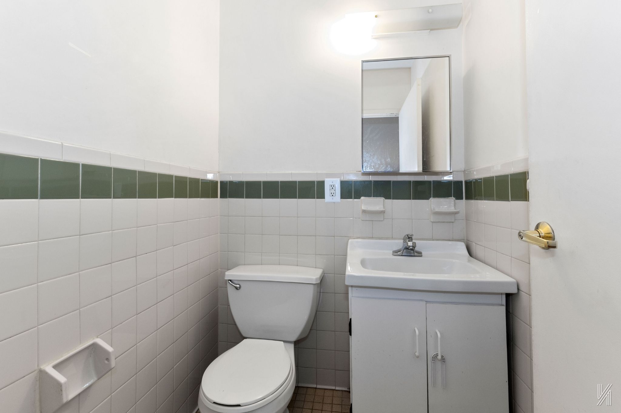 426 54th Street Brooklyn, NY 11220 - Photo 12 of 22 a bathroom with a toilet a sink and mirror