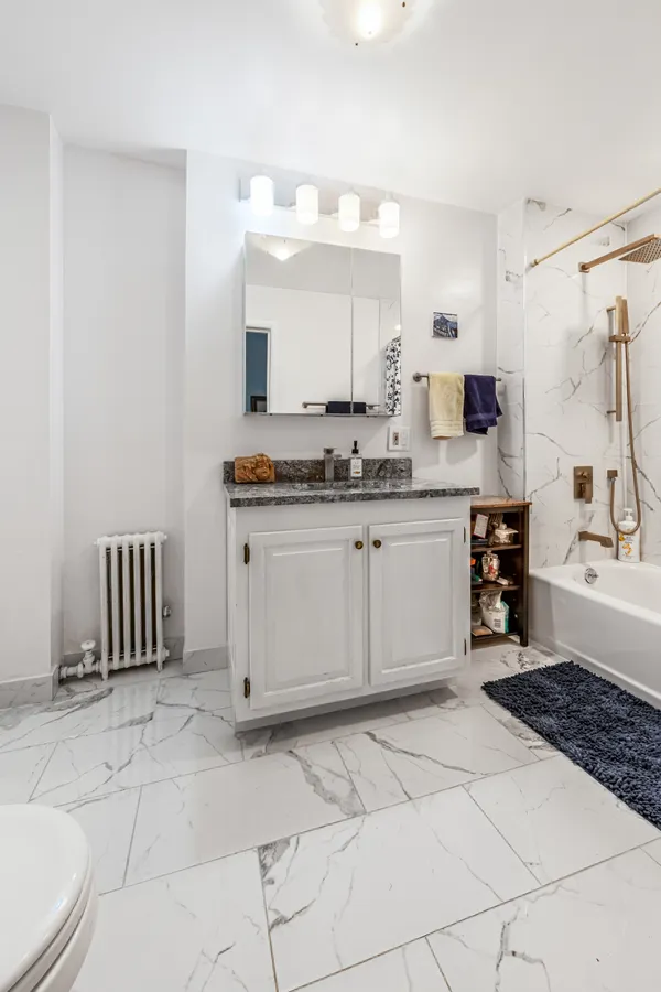 a large white kitchen with a sink and cabinets