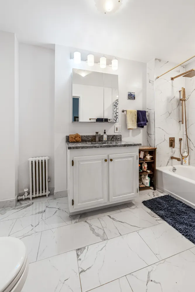 a large white kitchen with a sink and cabinets