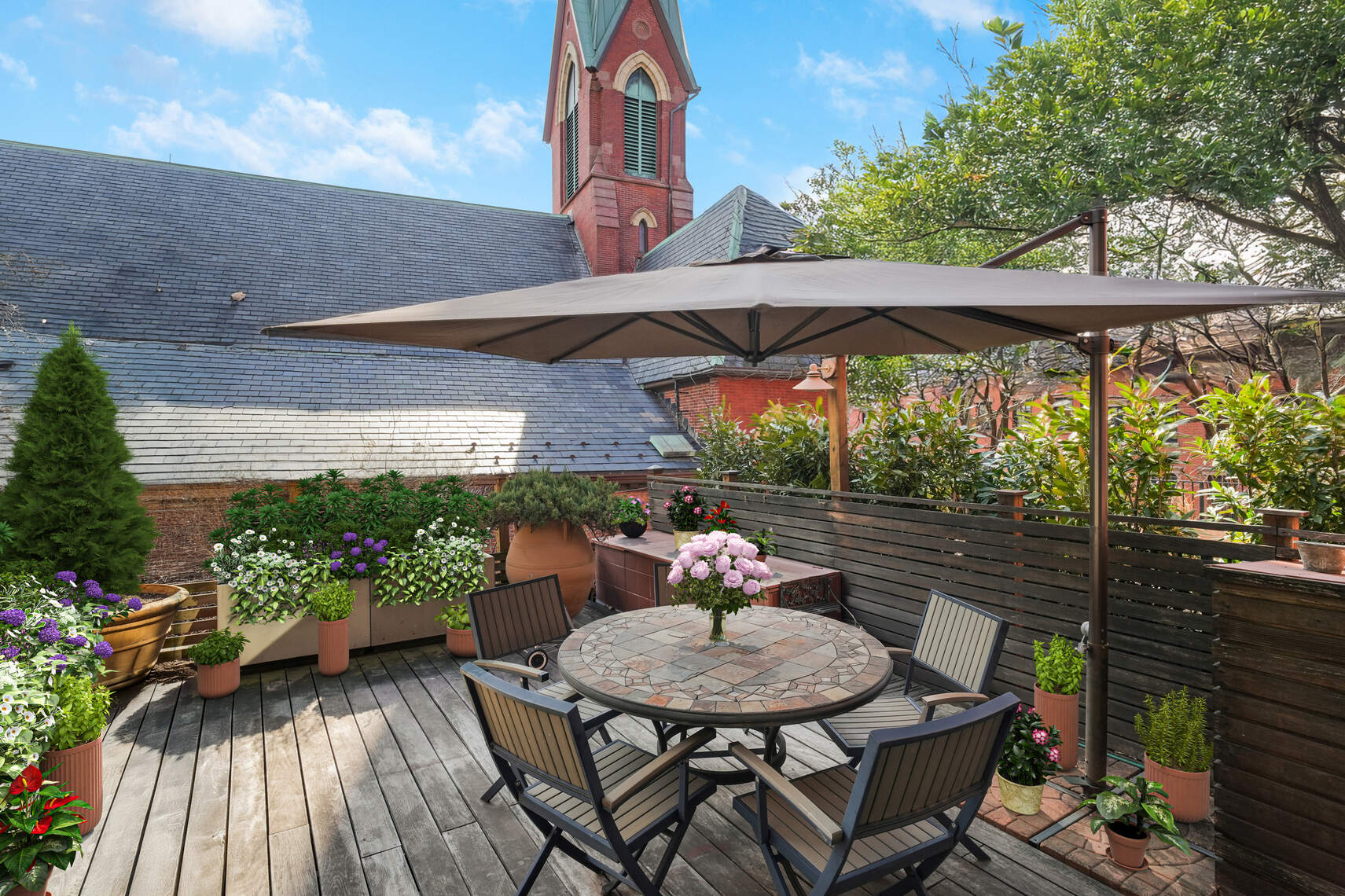 132 Joralemon Street, Unit 3BC Brooklyn, NY 11201 - Photo 1 of 16 a backyard of a house with table and chairs under an umbrella