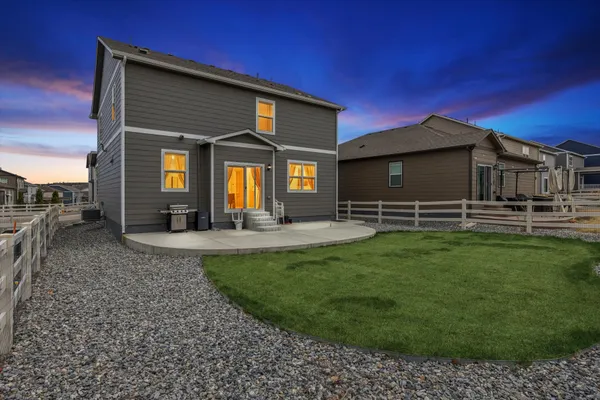 a view of a house with a backyard porch and sitting area