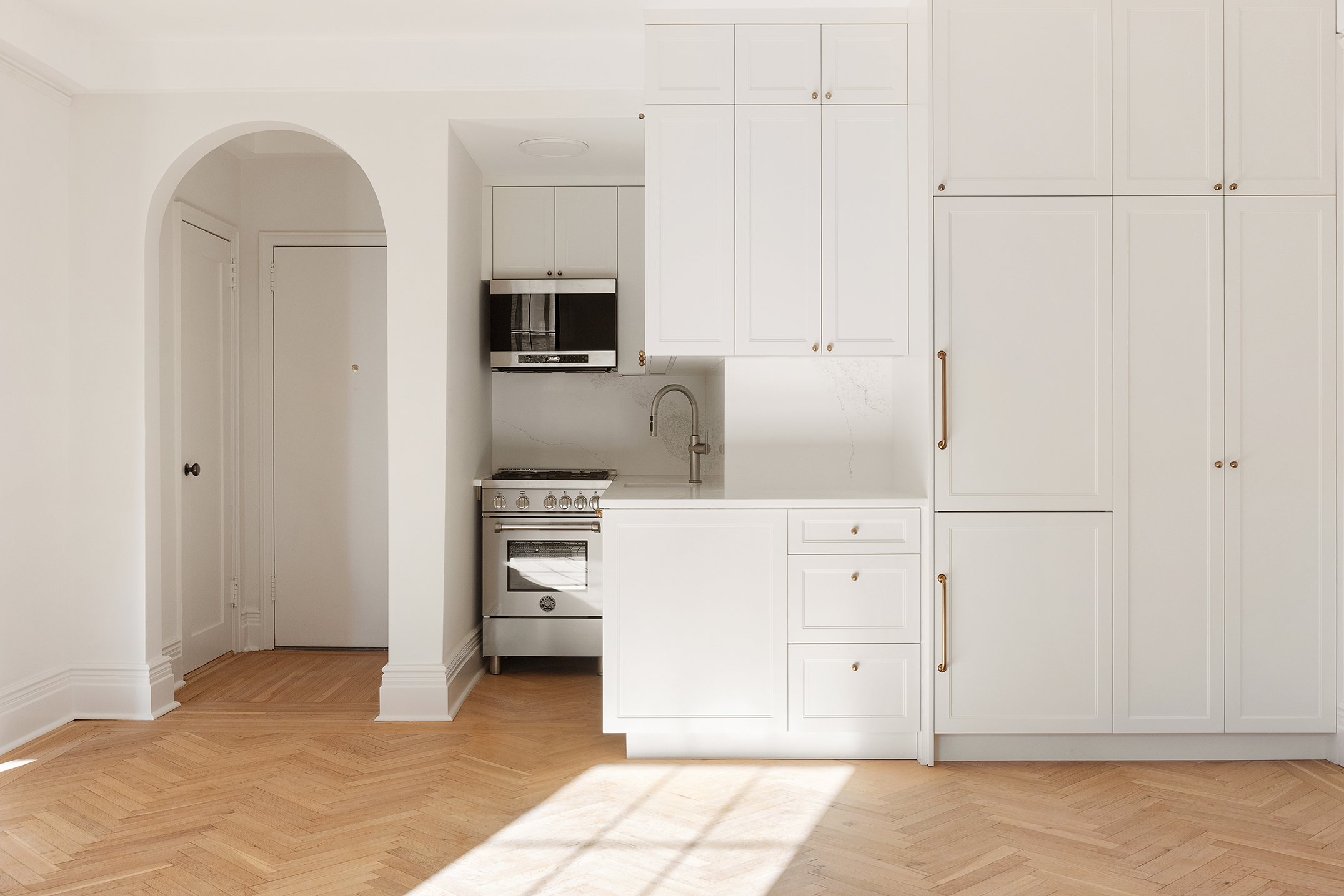23 East 74th Street, Unit 10A Manhattan, NY 10021 - Photo 4 of 10 a kitchen with cabinets and stainless steel appliances