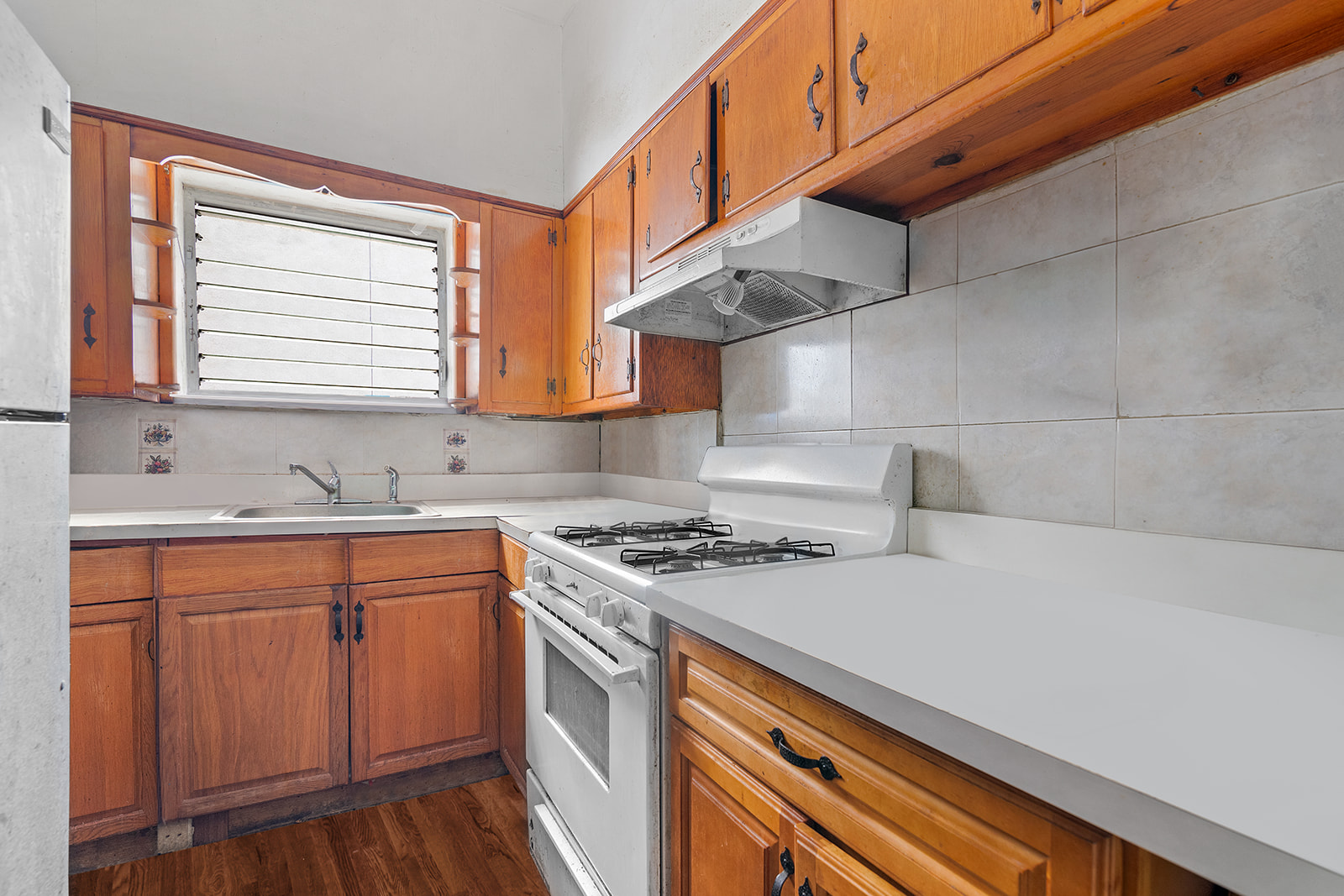 1168 Eastern Parkway Brooklyn, NY 11213 - Photo 4 of 9 a kitchen with stainless steel appliances a sink a stove and cabinets