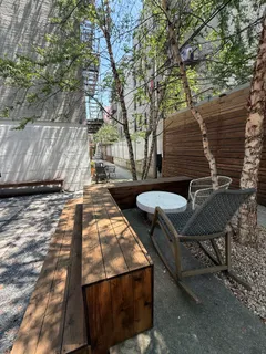 a backyard of a house with table and chairs