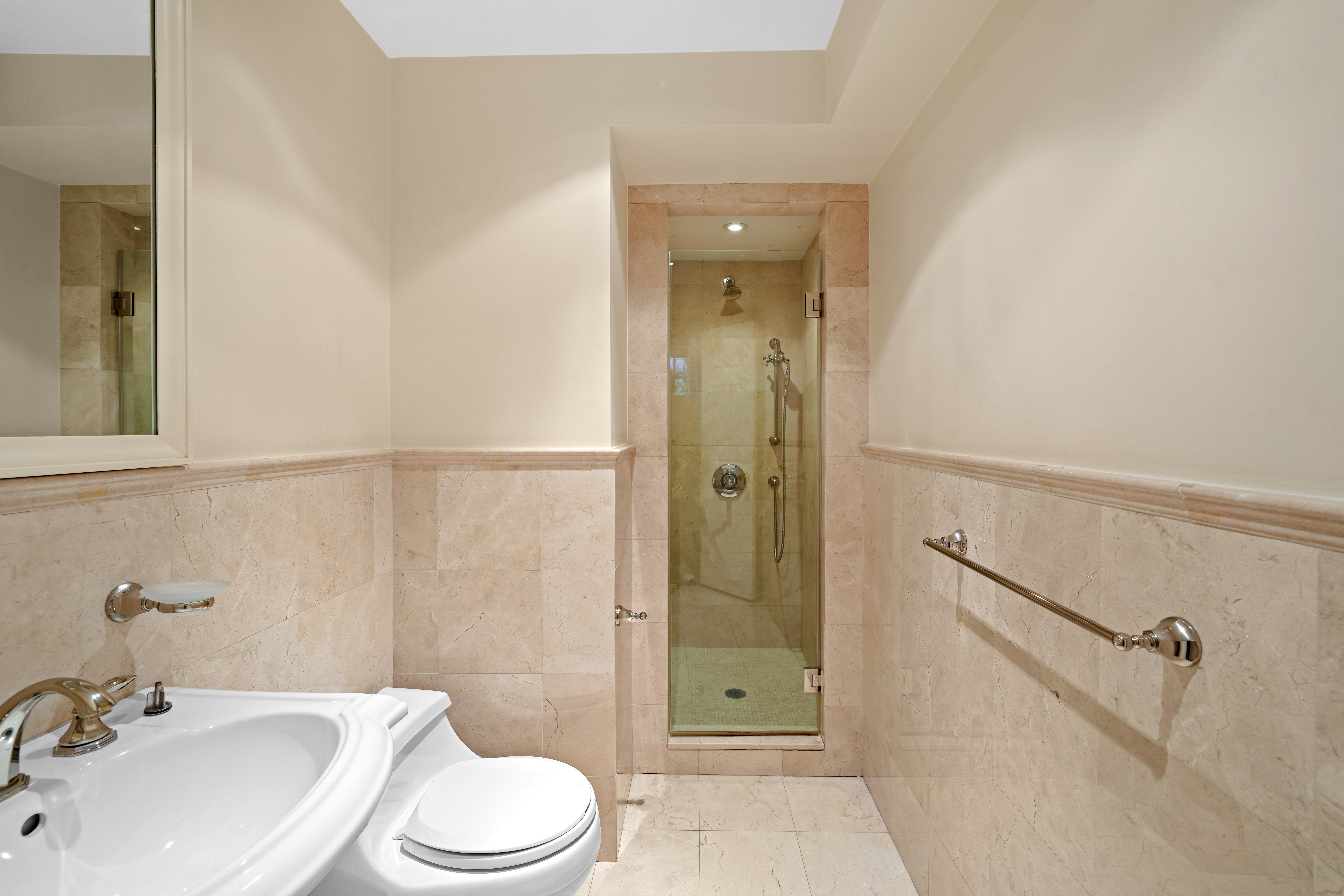 247 East 71st Street Manhattan, NY 10021 - Photo 28 of 31 a bathroom with a sink toilet and shower