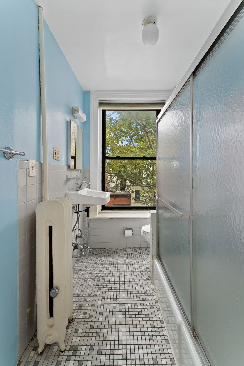 311 Henry Street, Unit 3 Brooklyn, NY 11201 - Photo 7 of 10 a bathroom with a bathtub and a large window