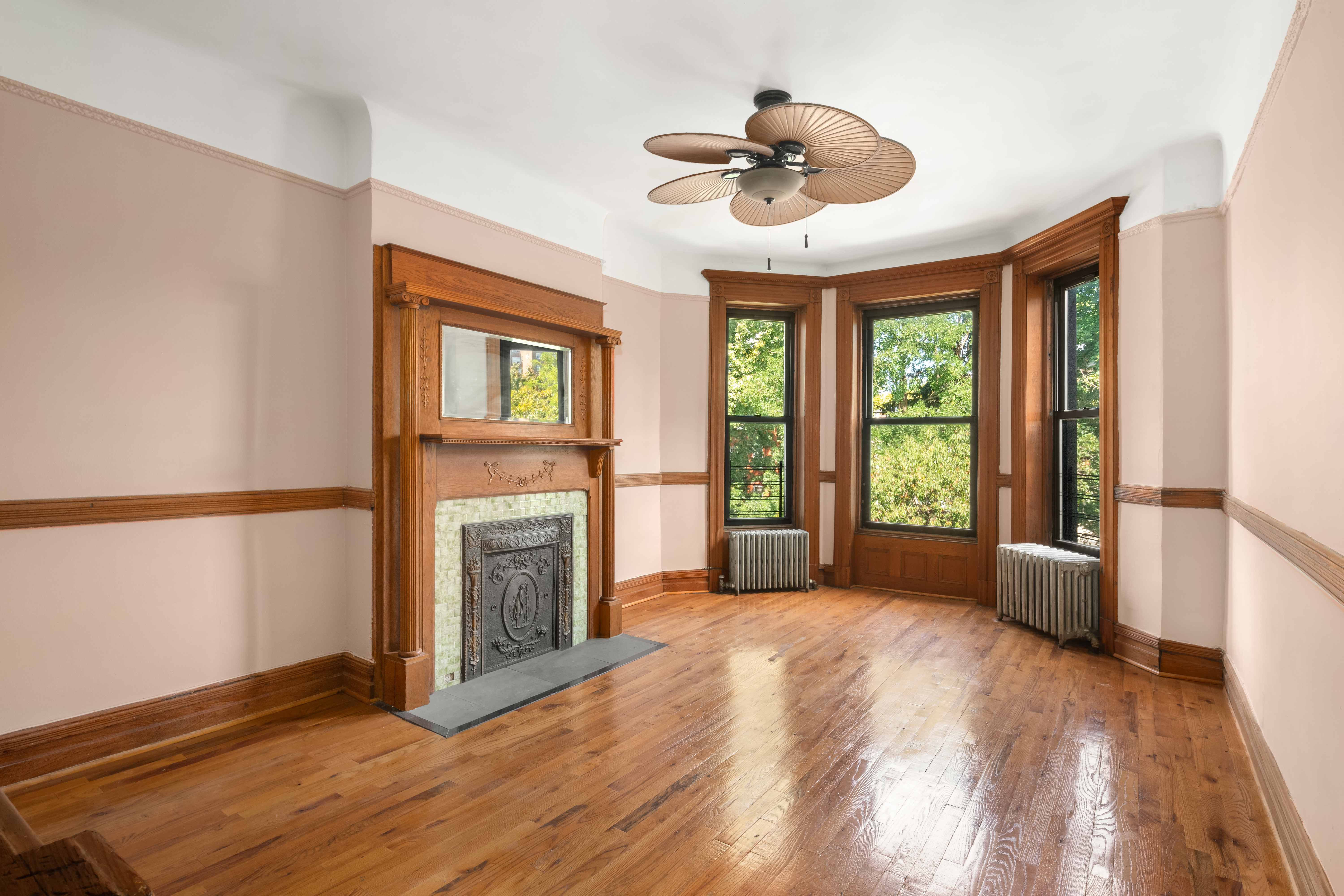 1135 Park Place Brooklyn, NY 11213 - Photo 11 of 18 a view of an empty room with a fireplace and a window