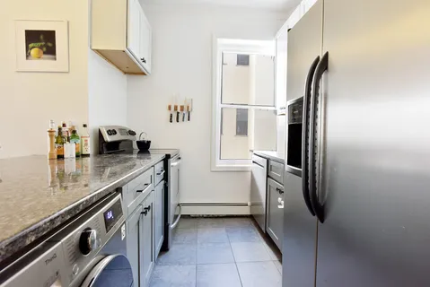 a kitchen with a refrigerator and countertop