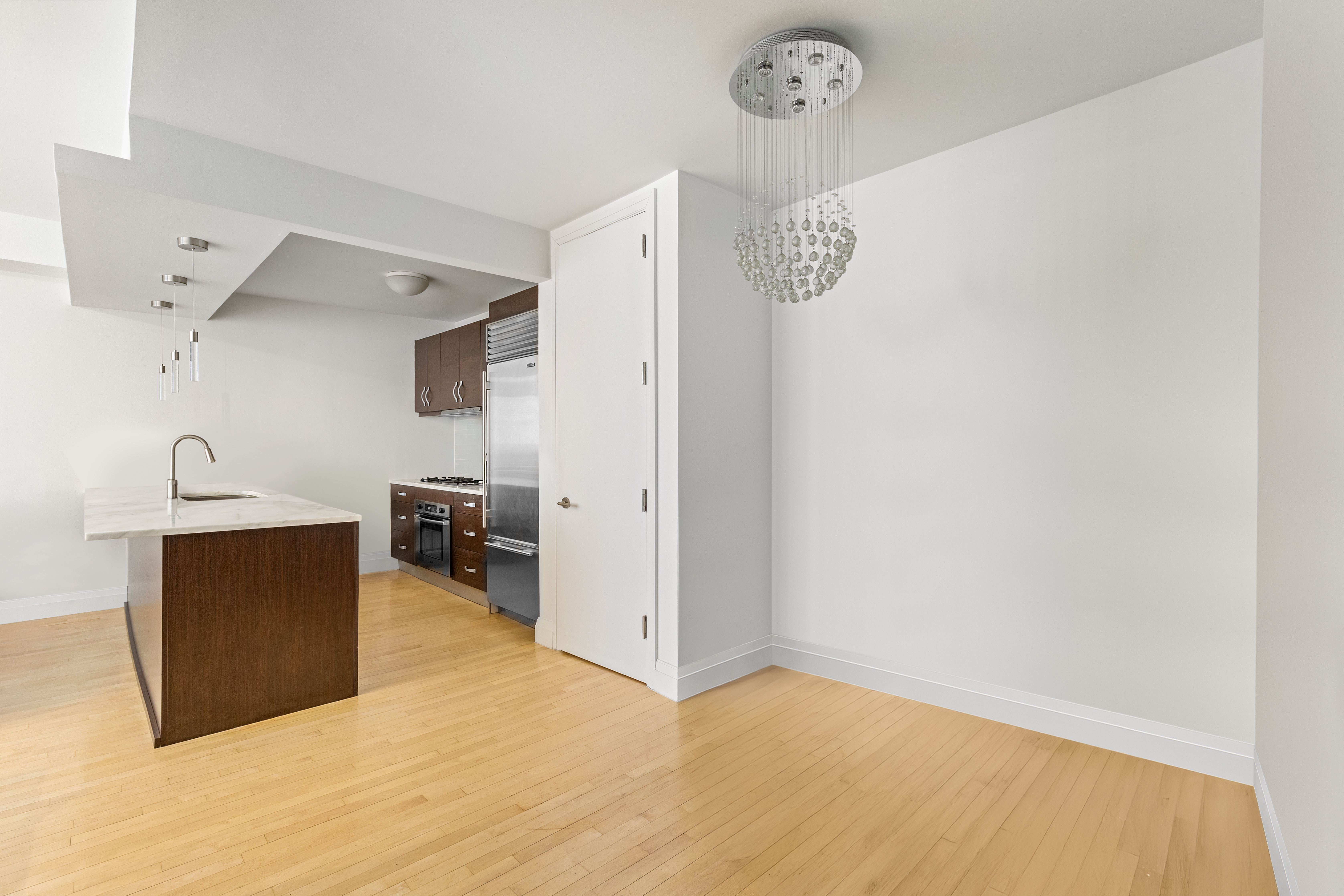 212 East 95th Street, Unit 2C Manhattan, NY 10128 - Photo 6 of 11 a view of kitchen with furniture and wooden floor
