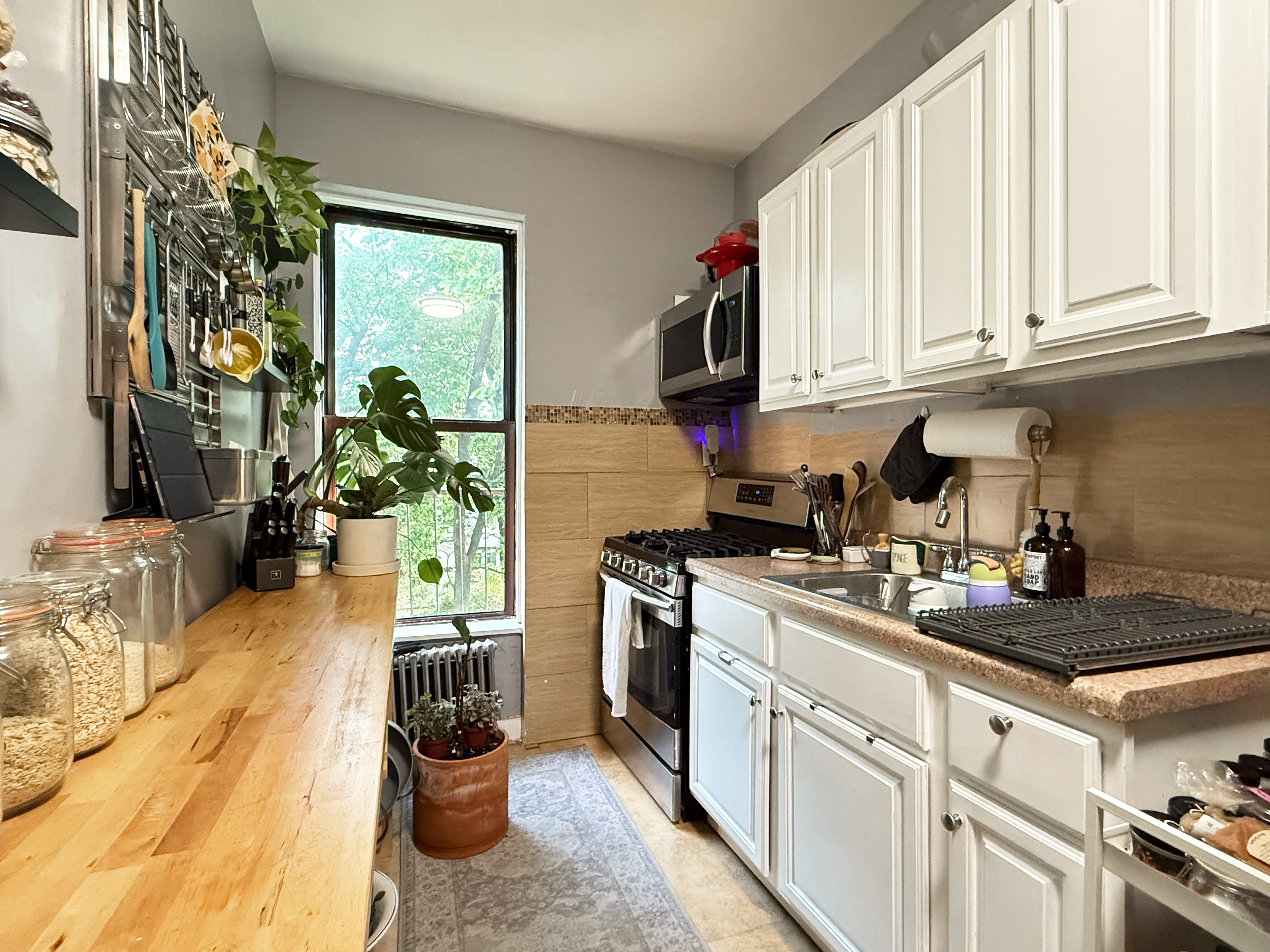 630 President Street, Unit 3 Brooklyn, NY 11215 - Photo 5 of 10 a kitchen with white cabinets and appliances