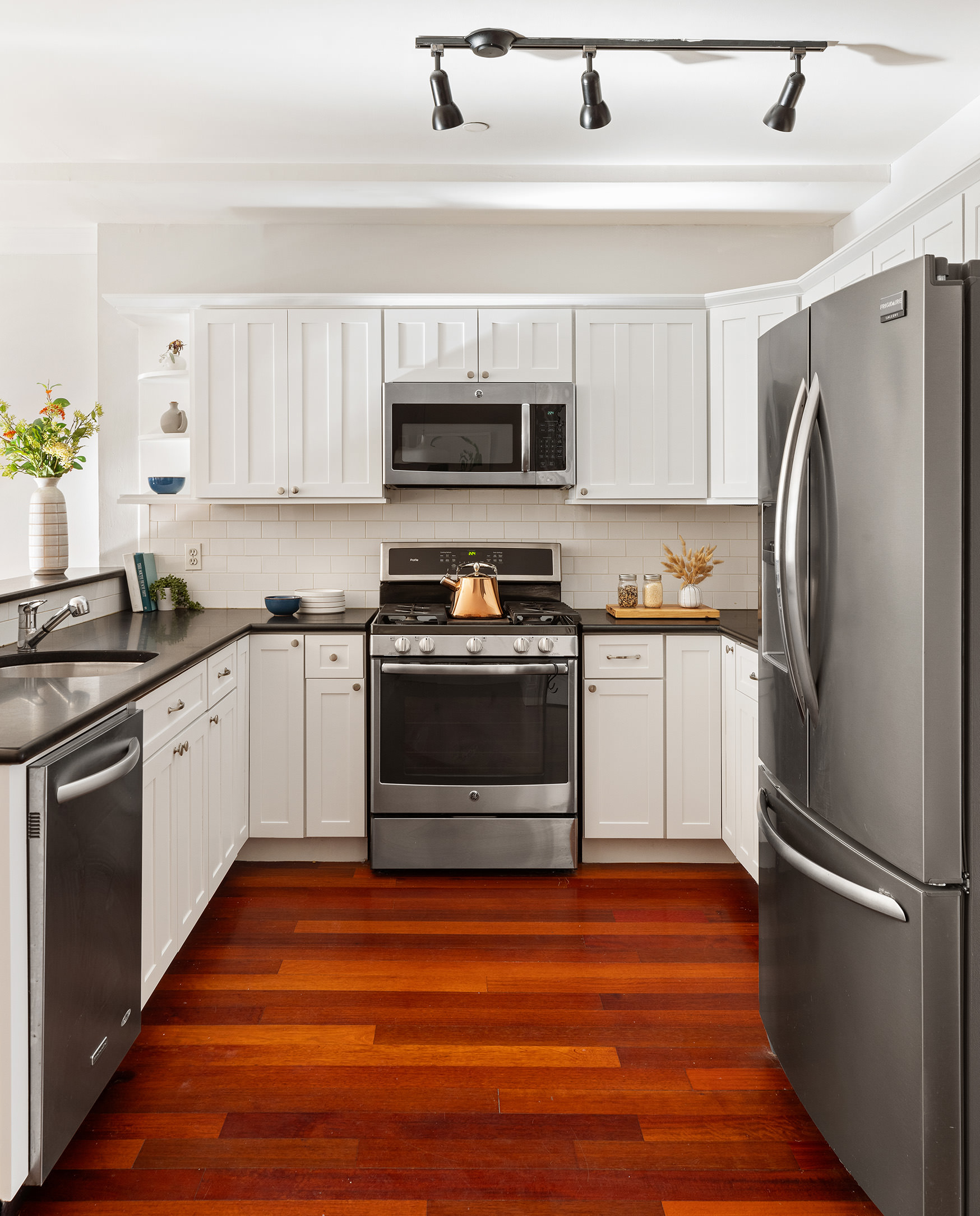 301 Warren Street, Unit 2 Brooklyn, NY 11201 - Photo 5 of 11 a kitchen with stainless steel appliances a refrigerator sink and white cabinets